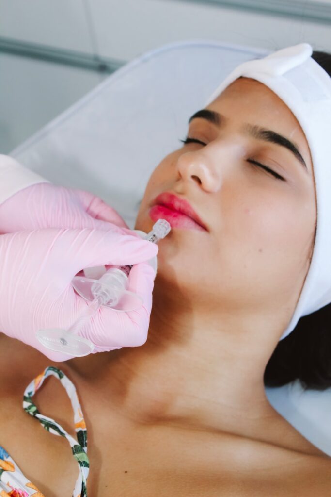 A woman in a hospital gown is getting an injection